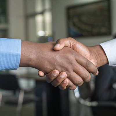 Professional handshake representing successful talent attraction