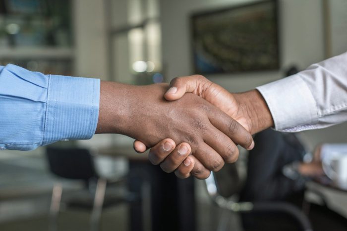 Professional handshake representing successful talent attraction