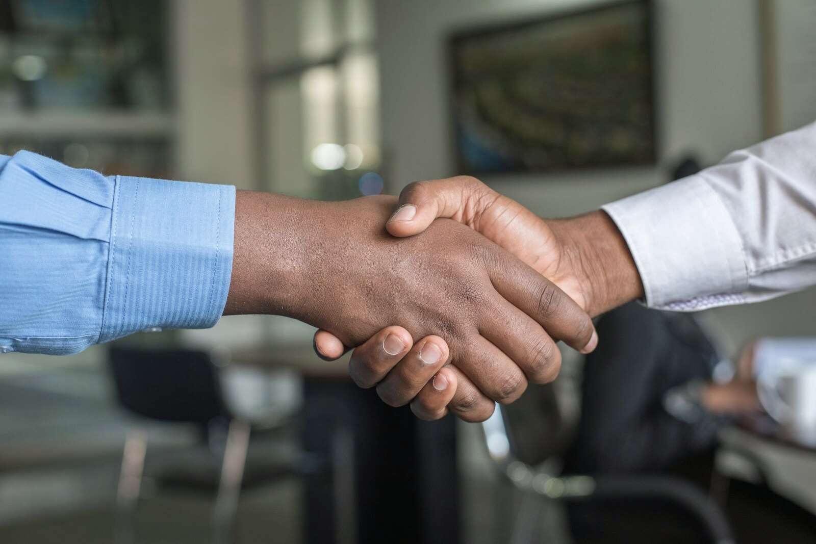 Professional handshake representing successful talent attraction