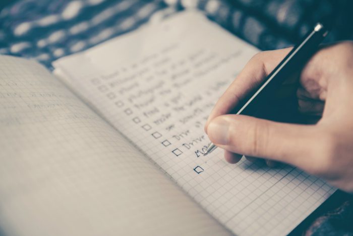 Hand completing a structured career planning checklist