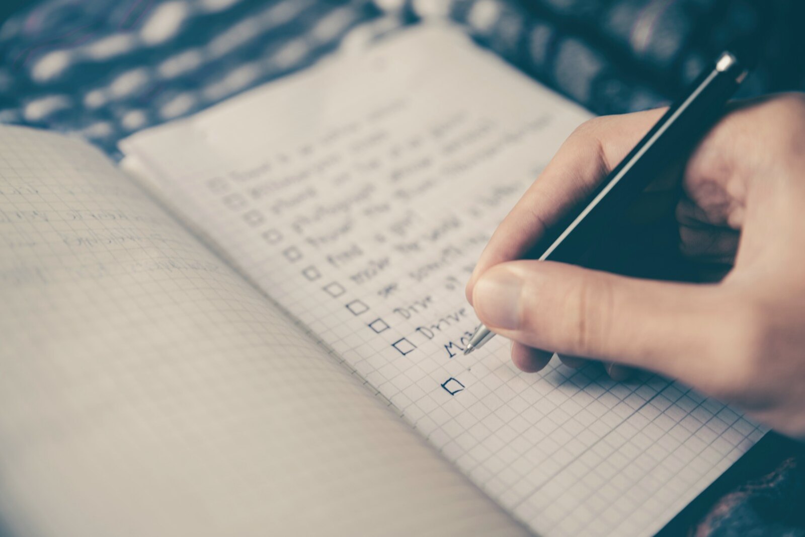 Hand completing a structured career planning checklist