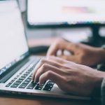 Professional working through an online job search on a laptop