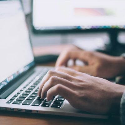 Professional working through an online job search on a laptop